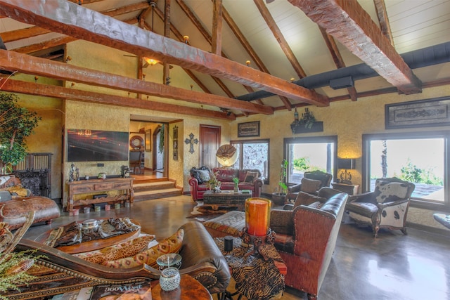 living room featuring a wealth of natural light, high vaulted ceiling, concrete floors, and beam ceiling