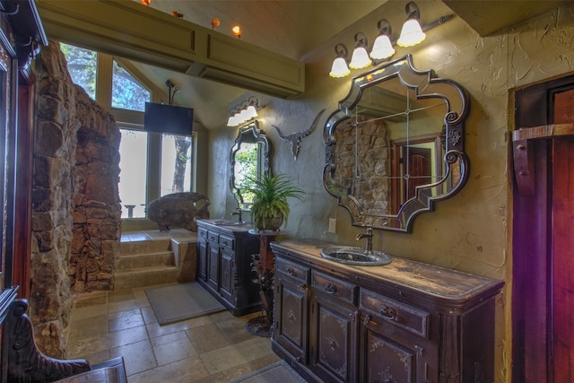 bathroom featuring a bathing tub, tile flooring, and double vanity