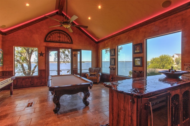 game room featuring ceiling fan, a water view, tile floors, high vaulted ceiling, and pool table