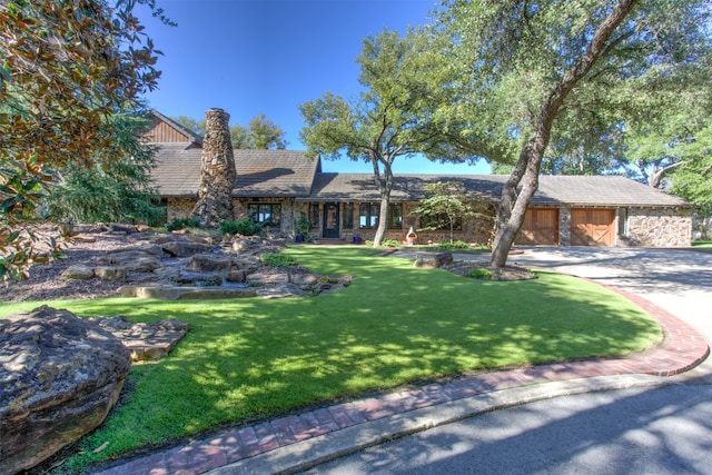 view of front of house with a garage and a front lawn