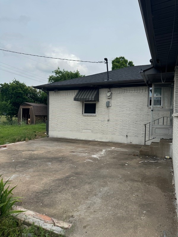 view of home's exterior with a storage shed