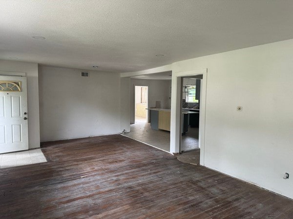 unfurnished room featuring dark hardwood / wood-style flooring and a textured ceiling