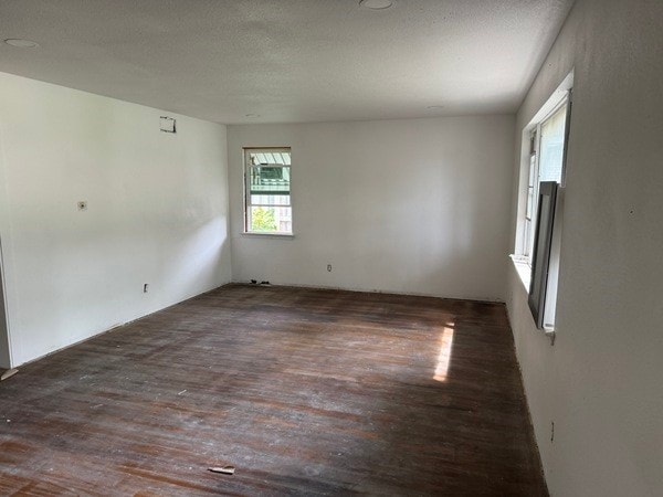 empty room with a textured ceiling and hardwood / wood-style floors