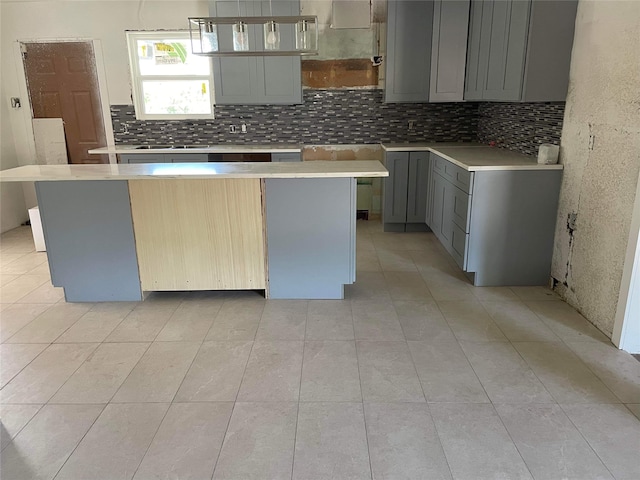 kitchen featuring a center island, light tile flooring, and tasteful backsplash