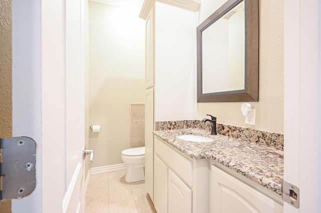 bathroom with tile patterned floors, vanity, and toilet