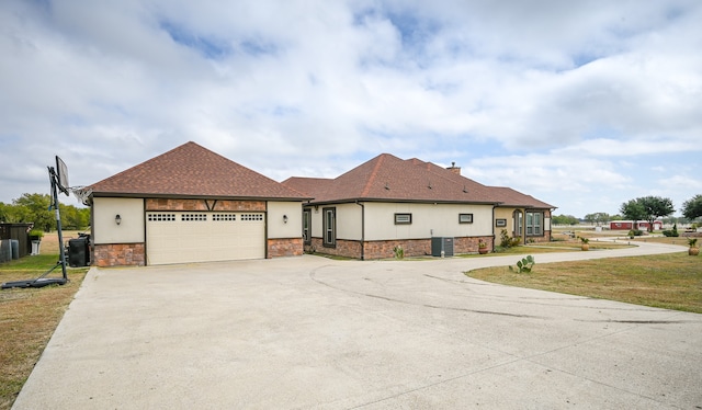 view of front facade with a garage and a front lawn