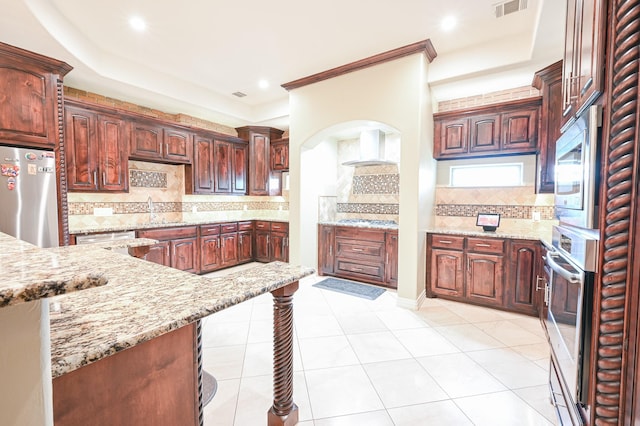 kitchen featuring backsplash, sink, light tile patterned floors, light stone counters, and stainless steel appliances