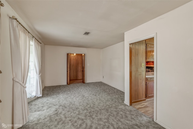 carpeted empty room with plenty of natural light