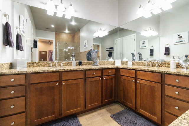 bathroom featuring vanity, an enclosed shower, and tile patterned floors