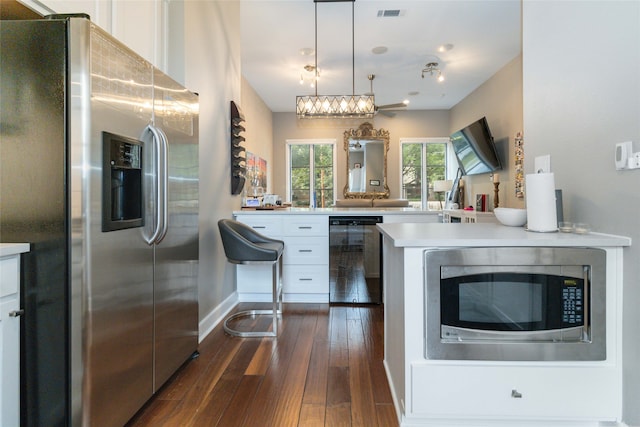 kitchen with kitchen peninsula, white cabinets, beverage cooler, dark hardwood / wood-style floors, and stainless steel appliances