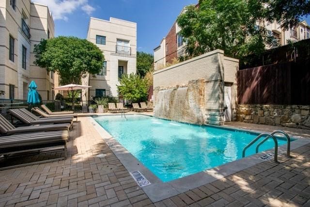 view of swimming pool featuring a patio area and pool water feature