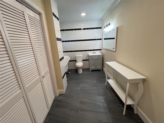 bathroom featuring toilet, ornamental molding, and vanity