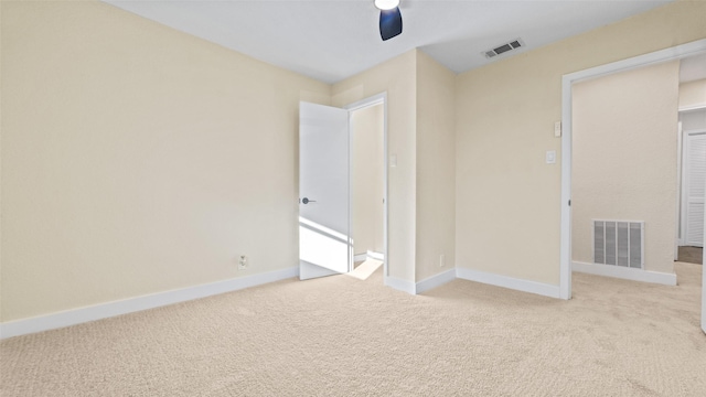 unfurnished bedroom featuring ceiling fan and light colored carpet