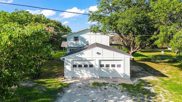 exterior space with an outbuilding, a front yard, and a garage