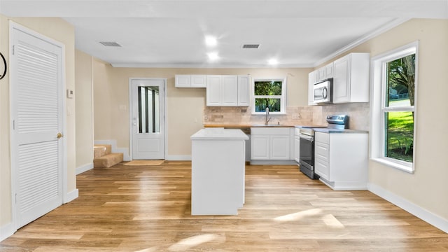 kitchen with appliances with stainless steel finishes, white cabinetry, and sink