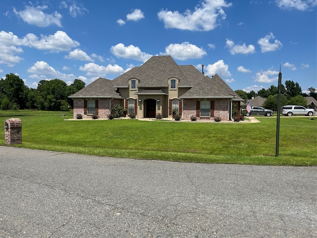 french country style house with a front yard