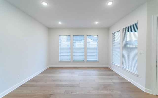 unfurnished room with light hardwood / wood-style flooring and a healthy amount of sunlight