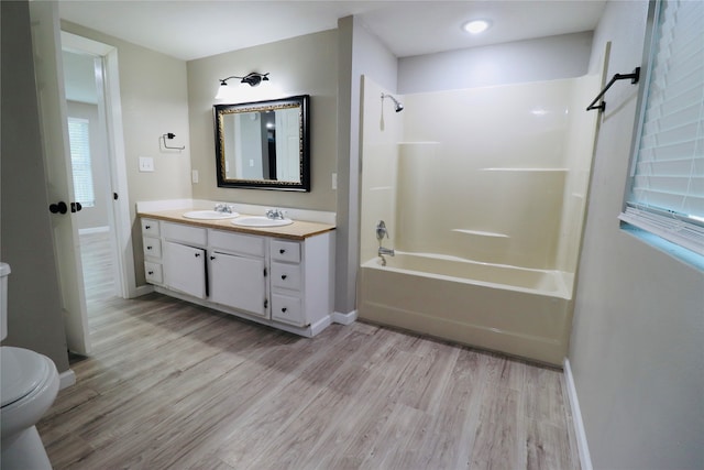 full bathroom with shower / bath combination, vanity, toilet, and wood-type flooring