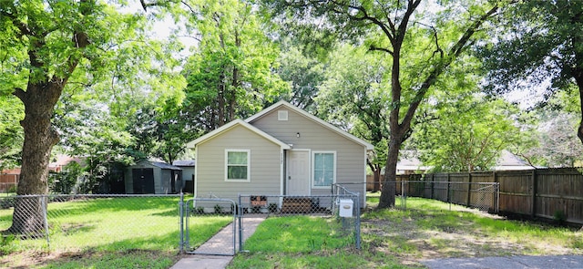 bungalow-style home featuring a front lawn