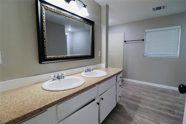 bathroom with hardwood / wood-style floors and vanity