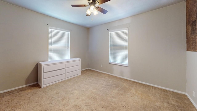 unfurnished bedroom with ceiling fan and light colored carpet