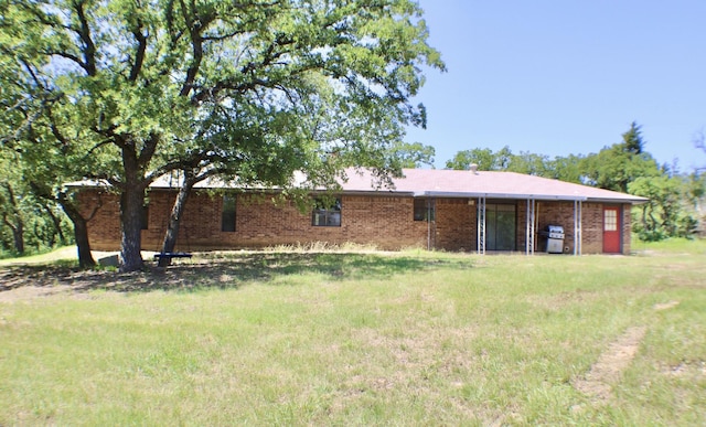 rear view of property with a yard