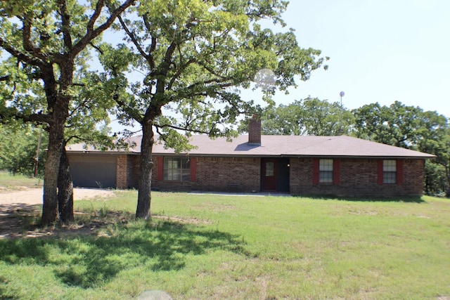 ranch-style house featuring a front yard and a garage