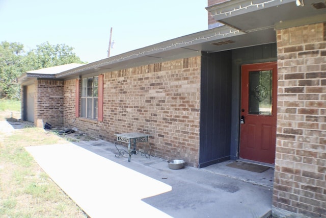 entrance to property with a patio area