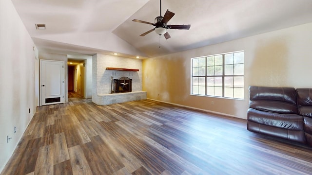 unfurnished living room featuring a brick fireplace, ceiling fan, hardwood / wood-style flooring, and vaulted ceiling