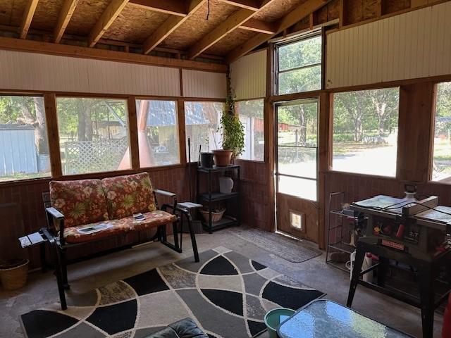 sunroom featuring lofted ceiling