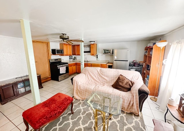 living room featuring light tile patterned flooring and ceiling fan