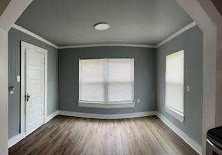 interior space with hardwood / wood-style floors, crown molding, and a wealth of natural light