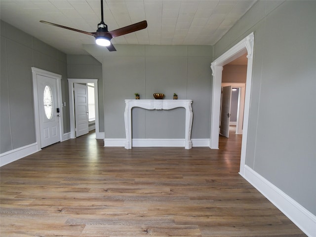 unfurnished living room featuring ceiling fan and wood-type flooring