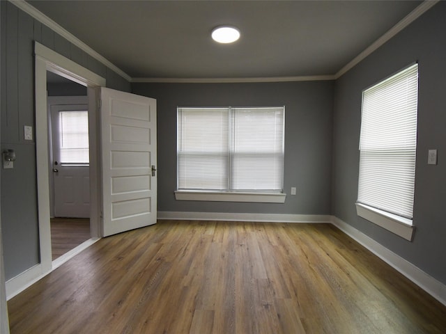 spare room featuring hardwood / wood-style floors and ornamental molding