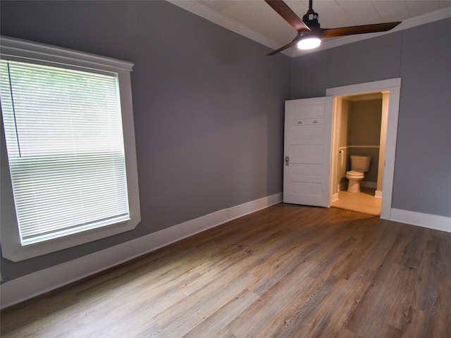 unfurnished bedroom with hardwood / wood-style flooring, ceiling fan, ornamental molding, and connected bathroom