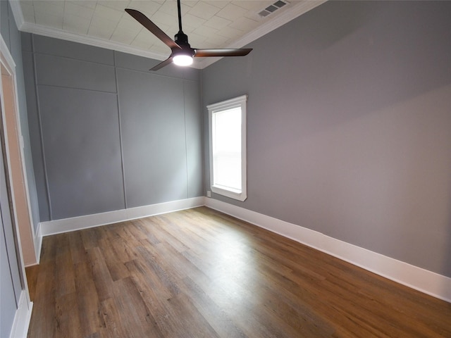 spare room featuring hardwood / wood-style floors, ceiling fan, and crown molding