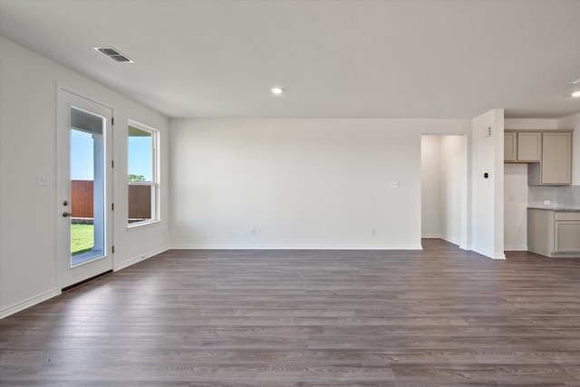 unfurnished living room with dark hardwood / wood-style flooring