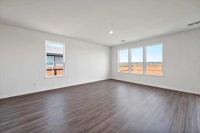 unfurnished room with dark wood-type flooring