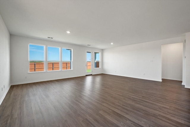 unfurnished living room featuring dark hardwood / wood-style flooring