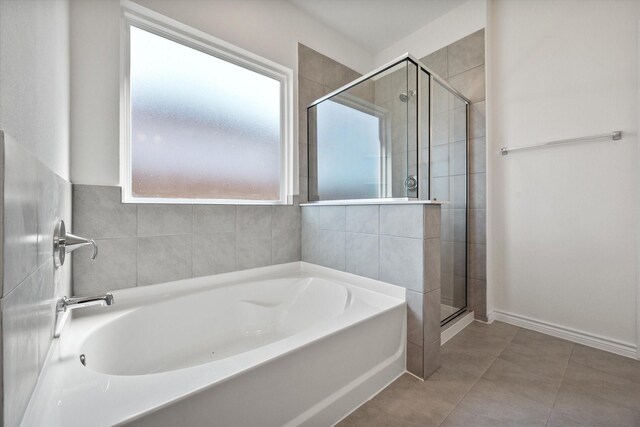 bathroom with separate shower and tub, plenty of natural light, and tile patterned floors