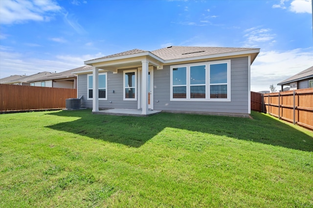 back of property with central AC unit, a yard, and a patio