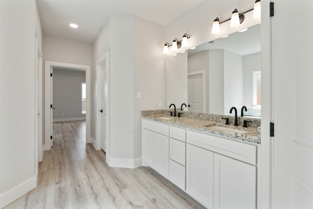 bathroom featuring wood-type flooring and vanity