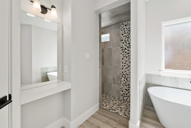 bathroom featuring wood-type flooring and independent shower and bath