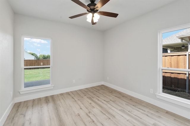 spare room featuring light wood-type flooring and ceiling fan