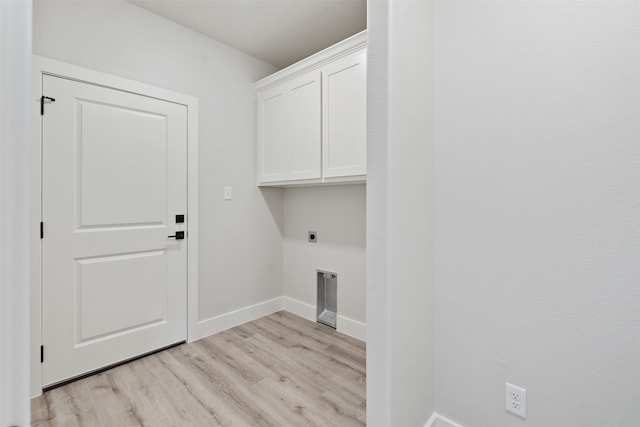 washroom featuring cabinets, light hardwood / wood-style floors, and electric dryer hookup