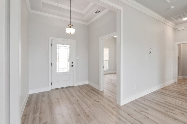 foyer entrance with crown molding, light wood-type flooring, and a wealth of natural light