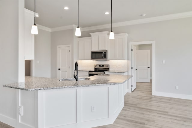 kitchen featuring sink, kitchen peninsula, hanging light fixtures, white cabinetry, and appliances with stainless steel finishes