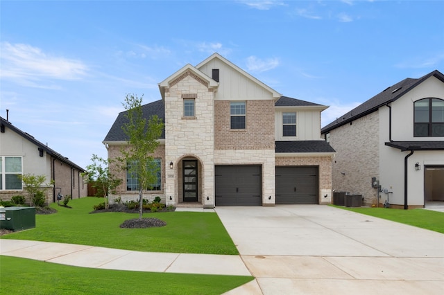 view of front of house with cooling unit, a garage, and a front lawn