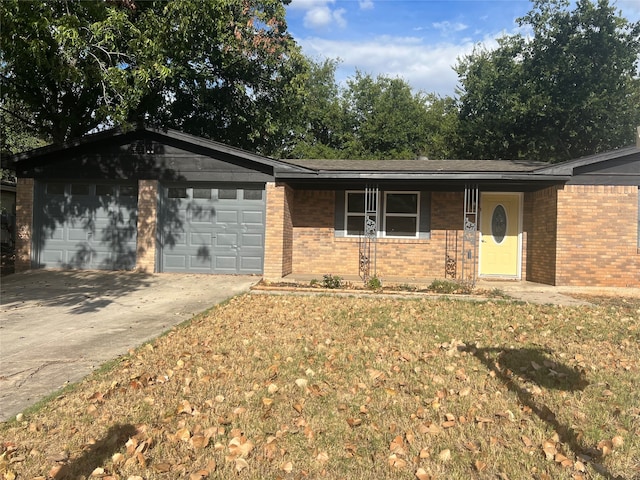 ranch-style house featuring a garage, a front yard, and covered porch