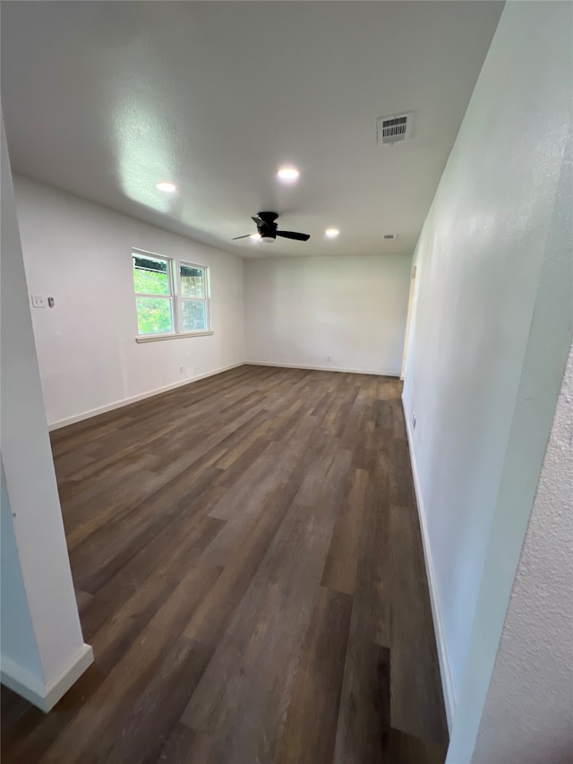 basement with ceiling fan and dark hardwood / wood-style floors